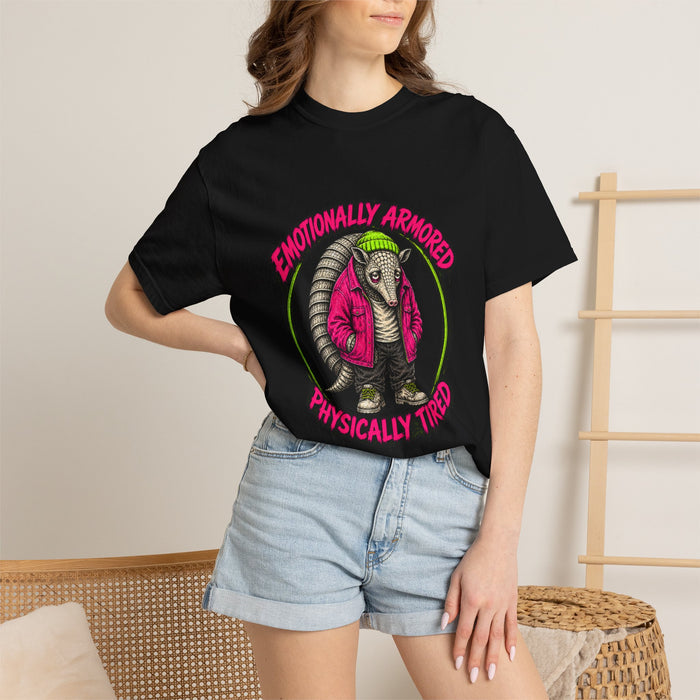 A person wearing the black Emotionally Armored Armadillo Tee t-shirt with denim shorts.