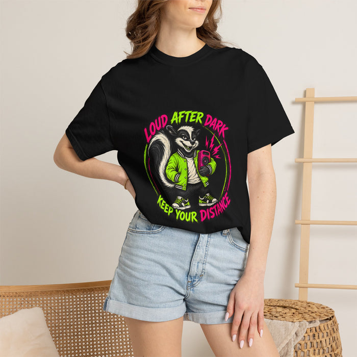 A person wearing the black Loud After Dark Skunk Tee t-shirt with denim shorts.