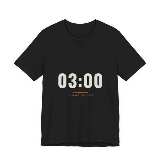 The time 03:00 in tall cream numerals above a thin rule and the words Night Shift, printed on a black unisex t-shirt.