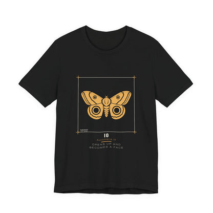A golden-yellow io moth with two dark ringed eyespots, drawn as a specimen plate inside a thin bracket frame with a 50 mm scale bar, labelled IO / Automeris io, printed on a black unisex t-shirt.