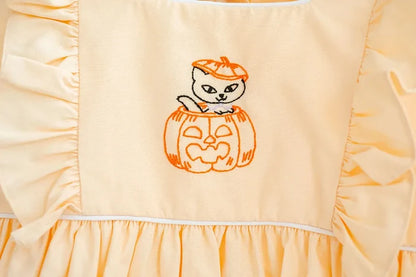 CLOSE UP OF HAND embroidered KITTY IN JACK O'LANTERN BUBBLE