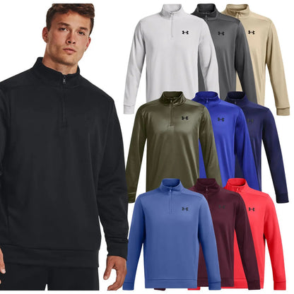 A young man stands wearing a black zip-up pullover next to a display of various colored sweatshirts including white gray green blue red and maroon in a clothing retail context.
