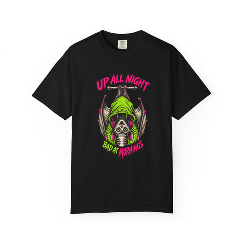 A neon green and pink cartoon bat hanging upside down from a branch, ringed by the words UP ALL NIGHT above and BAD AT MORNINGS below, printed on a black unisex t-shirt.