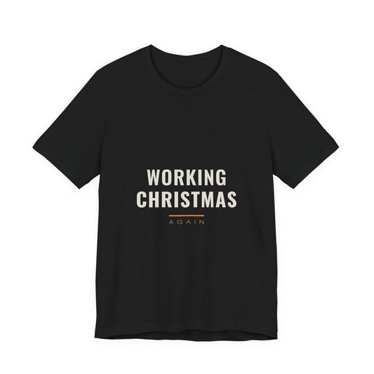 WORKING CHRISTMAS in two cream lines above an orange rule and the word AGAIN, printed on a black unisex t-shirt.